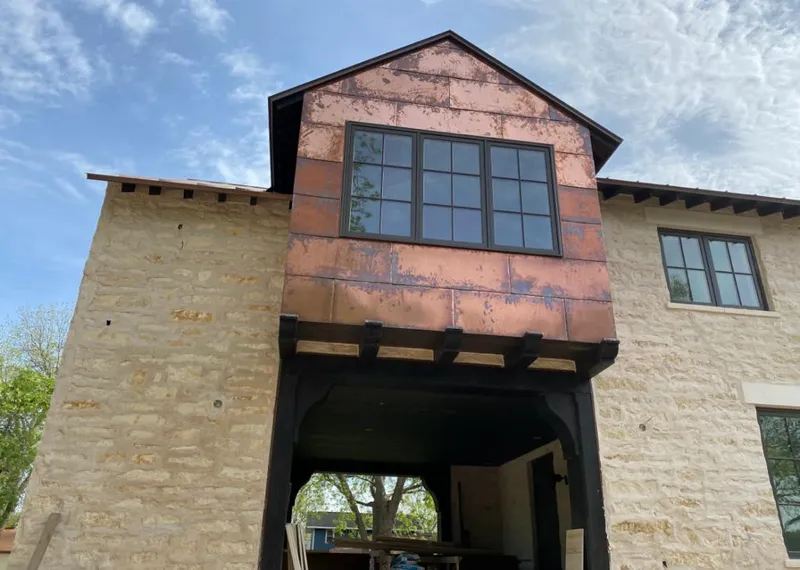 Copper metal panel facade on a stone building for Skylight Installation in Four Corners