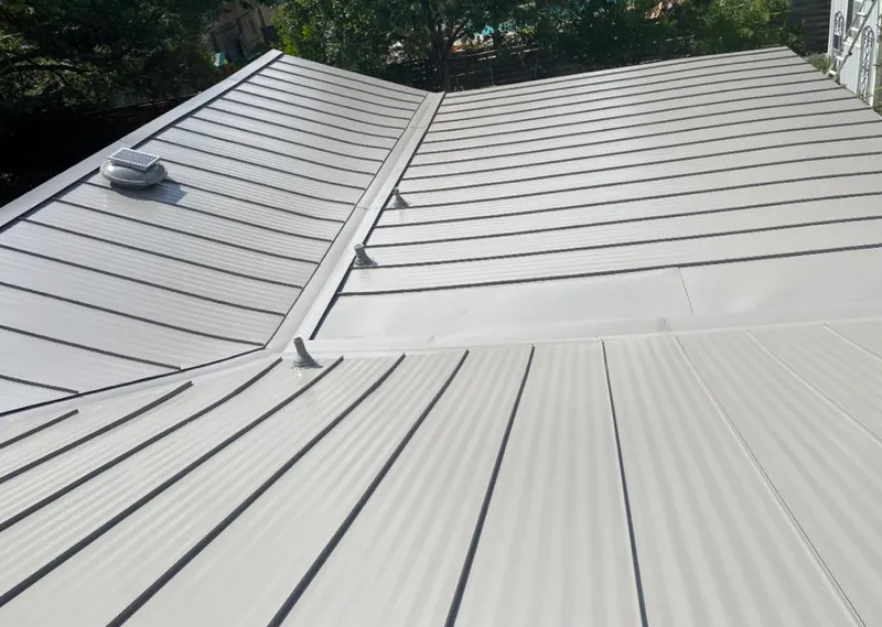 Solar attic fan installed on a metal roof for Roof Ventilation in Four Corners